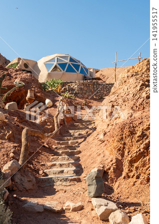 Eco glamping structure in the Sinai mountains, Dahab, Egypt. Unique dome design surrounded by desert landscape and cacti. Focus on eco tourism and camping. Eco glamping structure in the Sinai mountains, Dahab, Egypt. Unique dome design surrounded by desert landscape and cacti. Focus on eco tourism and camping. 141955517