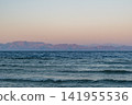 Blue waters of the Red Sea near Dahab, Egypt on the sunrise. Sinai mountains rise in the background under a clear sky. 141955536