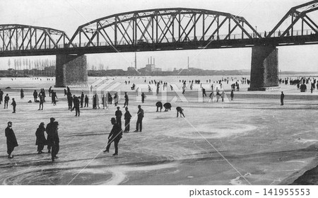Vintage photograph, 1933-1945, Pyongyang, North Korea during the Japanese colonial period: People enjoying skating on the frozen Taedong River. Vintage photograph, 1933-1945, Pyongyang, North Korea during the Japanese colonial period: People enjoying skating on the frozen Taedong River. 141955553