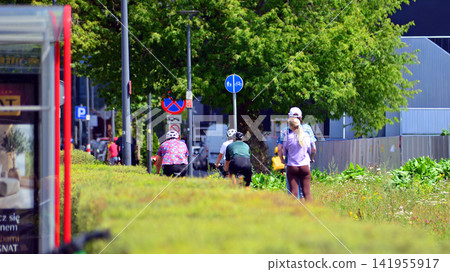 Warsaw, Poland. 25 July 2026. Cyclists on the urban bike path in the city Warsaw, Poland. 25 July 2026. Cyclists on the urban bike path in the city 141955917