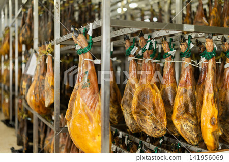 Legs of Spanish jamon ready for sale in grocery Legs of Spanish jamon ready for sale in grocery 141956069