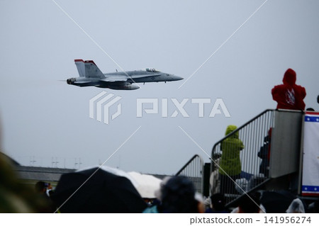 U.S. Marine Corps fighter jets flying at an air show and the crowd U.S. Marine Corps fighter jets flying at an air show and the crowd 141956274