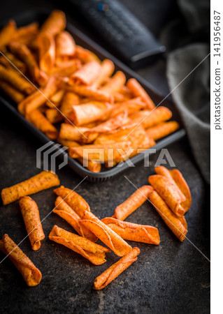 Crispy Spicy Taquitos Pile on Dark Surface Close-Up, Mexican Rolled Corn Snack 141956487