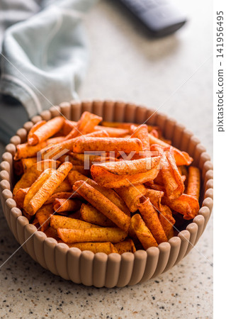 Spicy Rolled Snack Chips in a Bowl Ready for Movie Night or Casual TV Snacking Spicy Rolled Snack Chips in a Bowl Ready for Movie Night or Casual TV Snacking 141956495