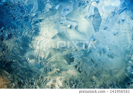 Abstract winter background texture of ice crystals freezing on blue surface Abstract winter background texture of ice crystals freezing on blue surface 141956581
