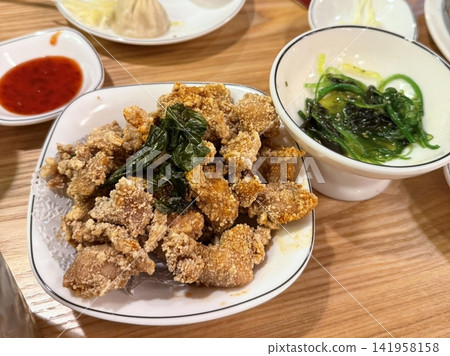 Crispy fried chicken with golden, crunchy skin and juicy, tender meat. A delicious and savory dish, perfect for any meal, served with dipping sauces or side dishes for extra flavor! Crispy fried chicken with golden, crunchy skin and juicy, tender meat. A delicious and savory dish, perfect for any meal, served with dipping sauces or side dishes for extra flavor! 141958158