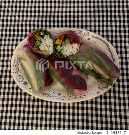 Vietnamese fresh spring rolls, or goi cuon, are light and refreshing. Rice paper wraps filled with shrimp, pork, vermicelli, and herbs, served with a tangy peanut dipping sauce. Perfect flavors. 141958247
