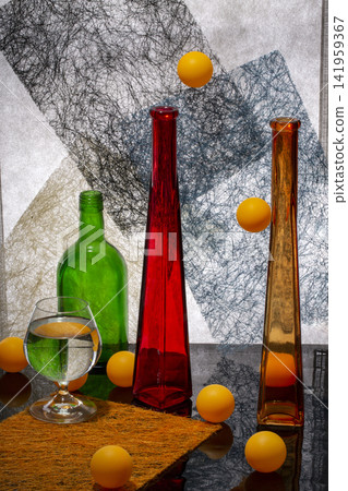 Still life with glassware and orange balls Still life with glassware and orange balls 141959367