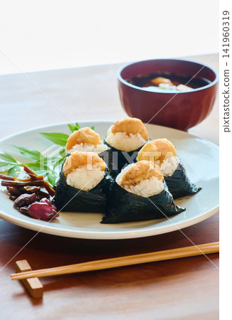 Japanese breakfast of shrimp tempura rice balls and miso soup served on a wooden table. Japanese breakfast of shrimp tempura rice balls and miso soup served on a wooden table. 141960319