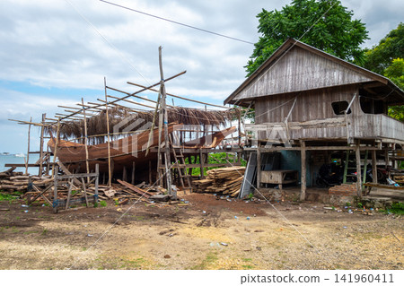 Traditional boat under construction in Tana Beru, Sulawesi, Indonesia Traditional boat under construction in Tana Beru, Sulawesi, Indonesia 141960411