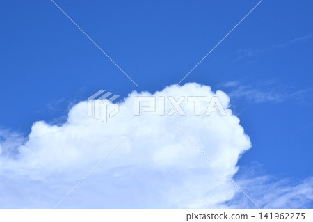 天空是藍色的,漂浮在藍天中的雲朵形狀不斷變化。 天空是藍色的,漂浮在藍天中的雲朵形狀不斷變化。 141962275
