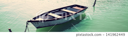 Morning on the lake. Boat near pier Morning on the lake. Boat near pier 141962449