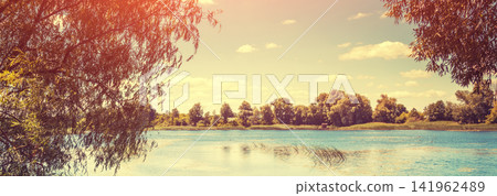 The shore of the lake on a bright sunny day The shore of the lake on a bright sunny day 141962489