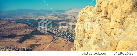 View from the Arbel cliff to the Arab villages of Migdal and Wadi al-Hammam, Galilee, Israel. 141962535