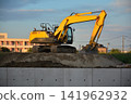 A power shovel stands at a construction site in the early morning. 141962932