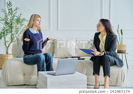 Teenage girl talking to female school psychologist Teenage girl talking to female school psychologist 141963174