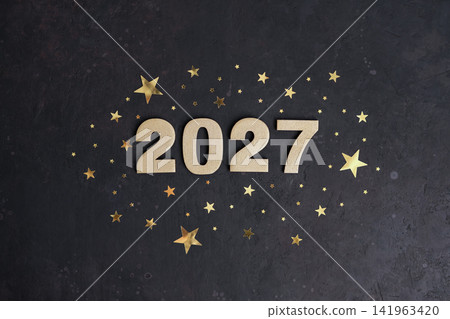 Golden numbers 2027 are centered on dark background surrounded by golden stars of varying sizes Golden numbers 2027 are centered on dark background surrounded by golden stars of varying sizes 141963420