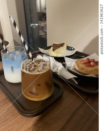 Cafe desserts featuring cakes, coffee, latte, and trendy drinks arranged beautifully. A cozy, modern selection that highlights sweetness, warmth, and a relaxed cafe lifestyle atmosphere. 141963627
