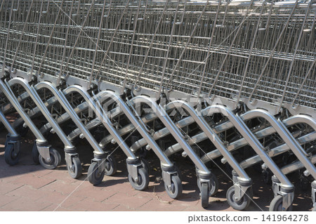 Row of empty shopping carts outside a store Row of empty shopping carts outside a store 141964278