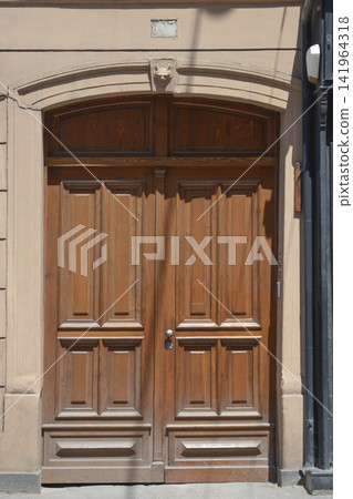 Historic wooden double entrance door with carved animal face keystone in Zagreb Historic wooden double entrance door with carved animal face keystone in Zagreb 141964318