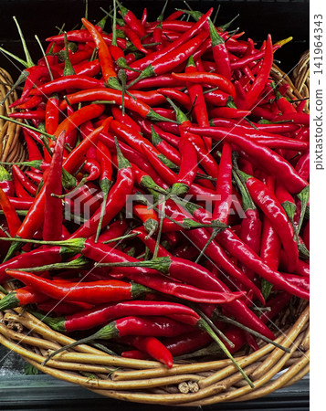 Fresh Red Chili Peppers in Wicker Basket at Farmers Market Fresh Red Chili Peppers in Wicker Basket at Farmers Market 141964343