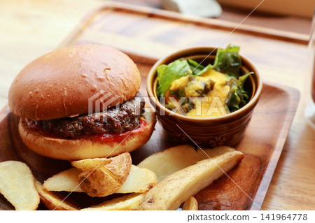 A plate of hamburger, french fries, and salad. A plate of hamburger, french fries, and salad. 141964778