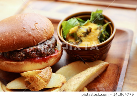 A plate of hamburger, french fries, and salad. A plate of hamburger, french fries, and salad. 141964779