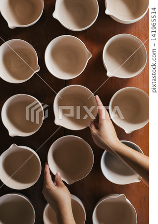 The process of creating pottery. The process of creating pottery. 141965514