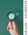 Hand holding magnifying glass over dollar currency sign on green background, financial audit and wealth search concept 141966556