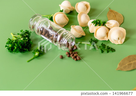 traditional dumplings with spices on a green background traditional dumplings with spices on a green background 141966677