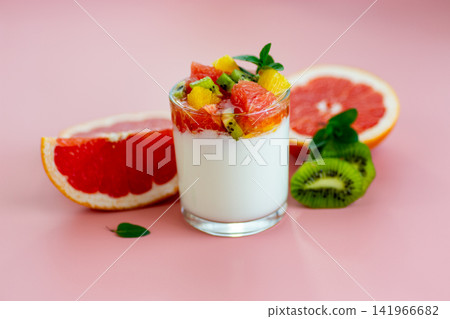 yogurt dessert with tropical fruits and citrus slices on minimal background yogurt dessert with tropical fruits and citrus slices on minimal background 141966682