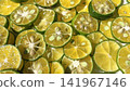 Close-up background photo with slices of shikwasa fruit laid out. 141967146