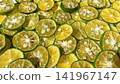 Close-up background photo with slices of shikwasa fruit laid out. 141967147