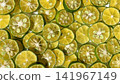 Close-up background photo with slices of shikwasa fruit laid out. 141967149