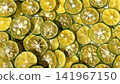 Close-up background photo with slices of shikwasa fruit laid out. 141967150