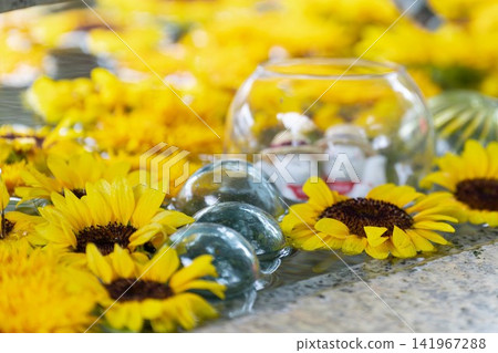 Takekoma Shrine: A summer tradition - a water basin adorned with vibrant yellow sunflowers. Takekoma Shrine: A summer tradition - a water basin adorned with vibrant yellow sunflowers. 141967288