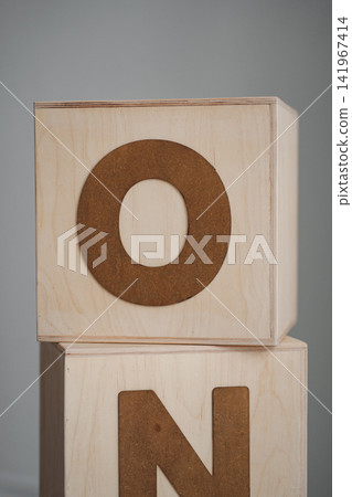 First birthday photo zone setup with wooden ONE blocks and cake stand 141967414