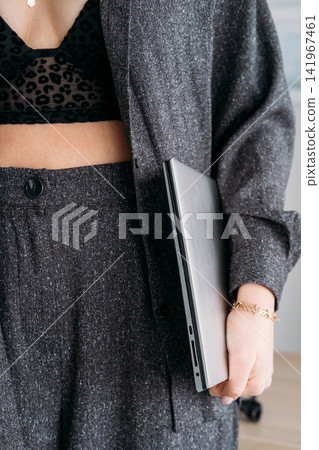 Laptop work. Freelance lifestyle. Unrecognizable stylish business woman specialist with computer for professional career routine. Laptop work. Freelance lifestyle. Unrecognizable stylish business woman specialist with computer for professional career routine. 141967461