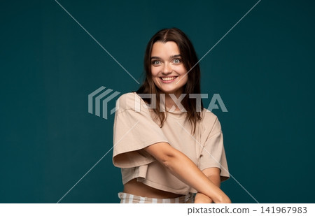 Young woman smiling with an excited expression, feeling happy and joyful, enjoying a positive moment Young woman smiling with an excited expression, feeling happy and joyful, enjoying a positive moment 141967983