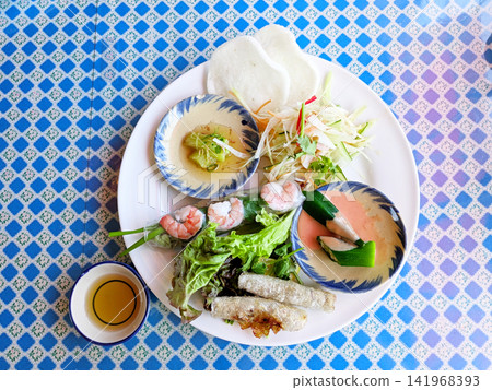 A one-plate lunch featuring both fresh and fried Vietnamese spring rolls. A one-plate lunch featuring both fresh and fried Vietnamese spring rolls. 141968393