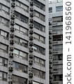 Air conditioner outdoor units lined up in an apartment building 141968560