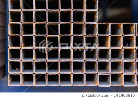 Close-Up of Stacked Square Metal Tubes with Rust Texture Close-Up of Stacked Square Metal Tubes with Rust Texture 141968610
