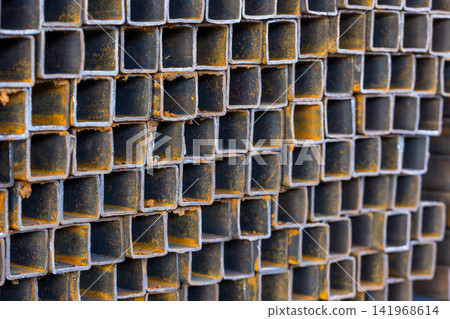 Close-Up of Stacked Square Metal Tubes with Rust Texture Close-Up of Stacked Square Metal Tubes with Rust Texture 141968614