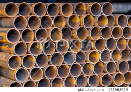 Close-up of Stacked Rusty Metal Pipes 141968619