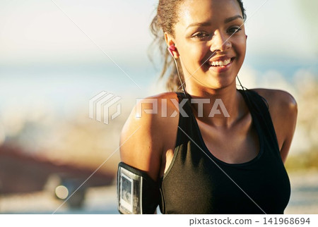 Woman, portrait and outdoor exercise with earphones or arm running strap for podcast, fitness app or workout. Female person, face and smile for music streaming in summer, subscription or playlist Woman, portrait and outdoor exercise with earphones or arm running strap for podcast, fitness app or workout. Female person, face and smile for music streaming in summer, subscription or playlist 141968694