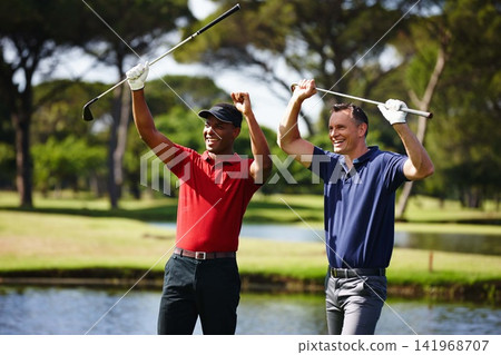 Happy man, golfer and celebration with club for winning, point or score in outdoor nature. Young male person, friends or people with smile for teamwork, victory or match on grass field or golf course Happy man, golfer and celebration with club for winning, point or score in outdoor nature. Young male person, friends or people with smile for teamwork, victory or match on grass field or golf course 141968707