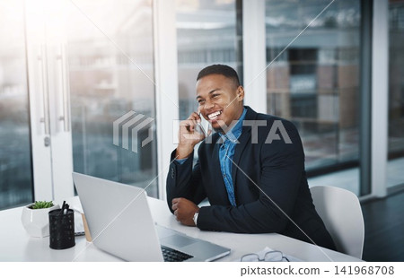 Happy businessman, laptop and discussion with phone call for proposal or communication at office desk. Black man, accountant or employee with smile on mobile smartphone for friendly conversation Happy businessman, laptop and discussion with phone call for proposal or communication at office desk. Black man, accountant or employee with smile on mobile smartphone for friendly conversation 141968708
