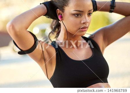 Fitness, outdoor and woman with earphones for sit up exercise for health, wellness and body training. Sports, nature and female athlete listening to music, radio or podcast for abdomen workout. Fitness, outdoor and woman with earphones for sit up exercise for health, wellness and body training. Sports, nature and female athlete listening to music, radio or podcast for abdomen workout. 141968789