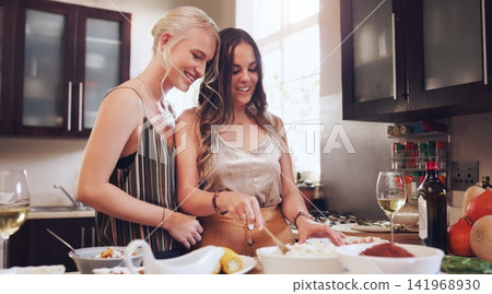 Lesbian, couple or kitchen or happy with dinner for family, food for cooking or holidays. Female chefs or meal with lgbt partner in home and together, relax with smile or love with celebration 141968930