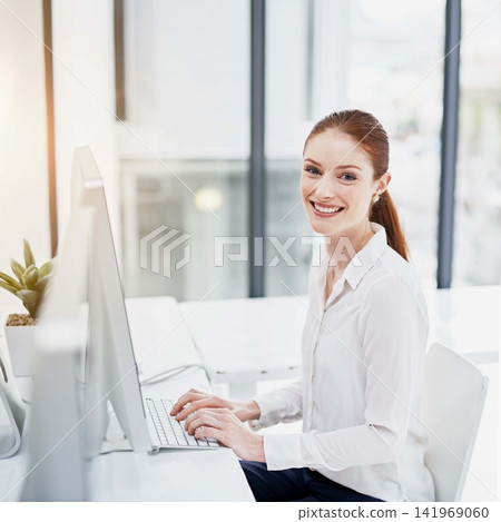 Computer, portrait and smile with business woman at desk in office for online administration. Desktop, flare and typing on keyboard with happy young professional employee in workplace for report Computer, portrait and smile with business woman at desk in office for online administration. Desktop, flare and typing on keyboard with happy young professional employee in workplace for report 141969060